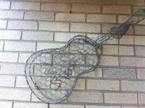 Recycled Metal wire guitar with hands