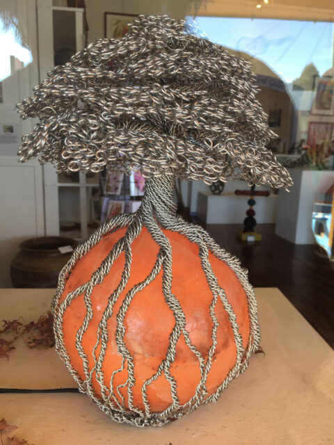 Livewire Sculpture's round Himalayan Salt Lamp with bonsai style armature wire Tree with curved leaves and roots encircling the lamp base 